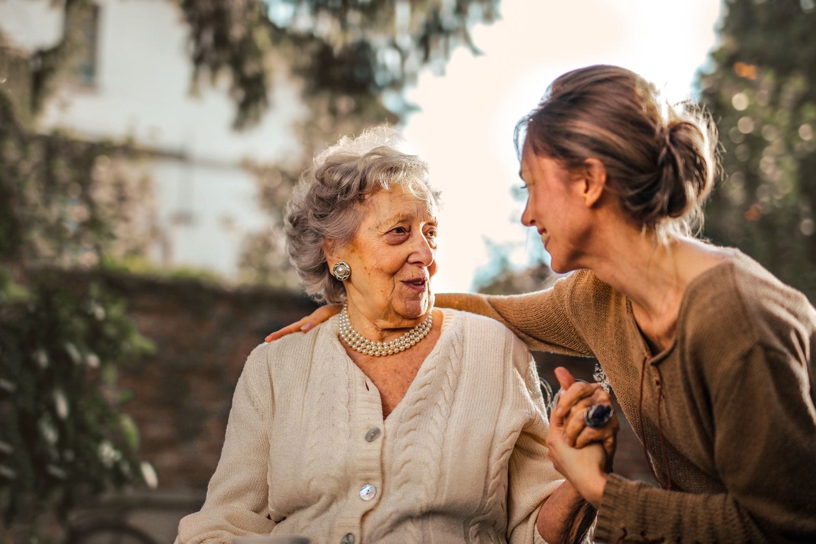 Senior and family member sharing a warm moment outdoors