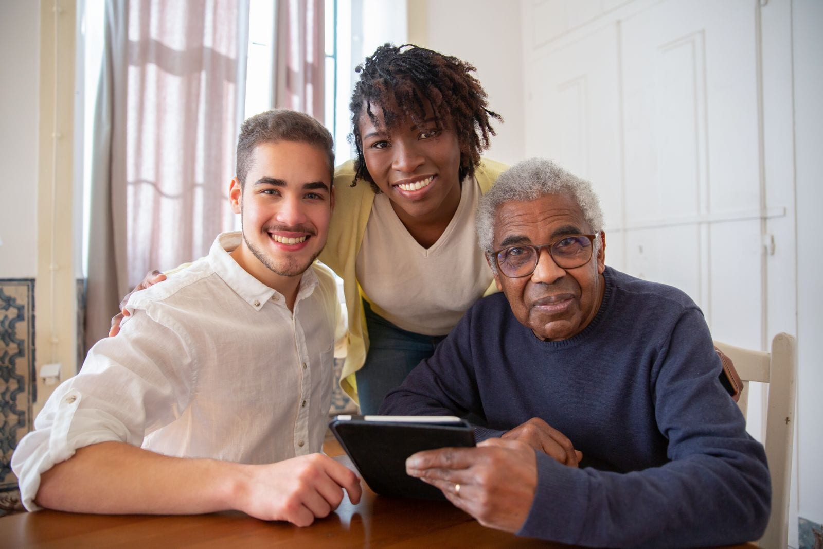 Senior and family members using a tablet together